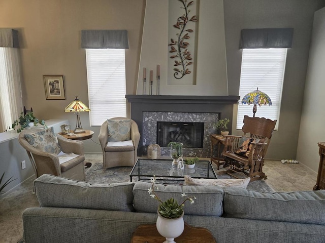 carpeted living room with plenty of natural light and a high end fireplace