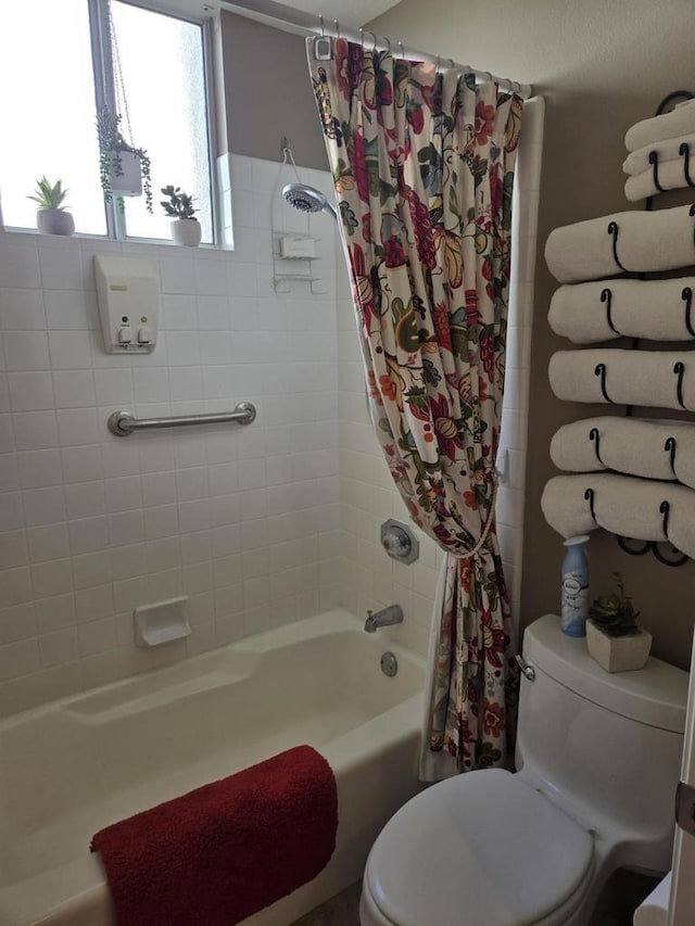 bathroom featuring toilet and shower / bath combo with shower curtain