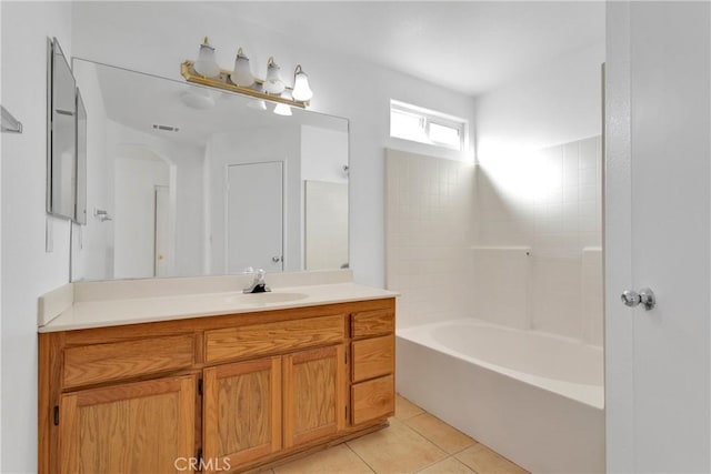 bathroom featuring tile patterned flooring, vanity, and washtub / shower combination