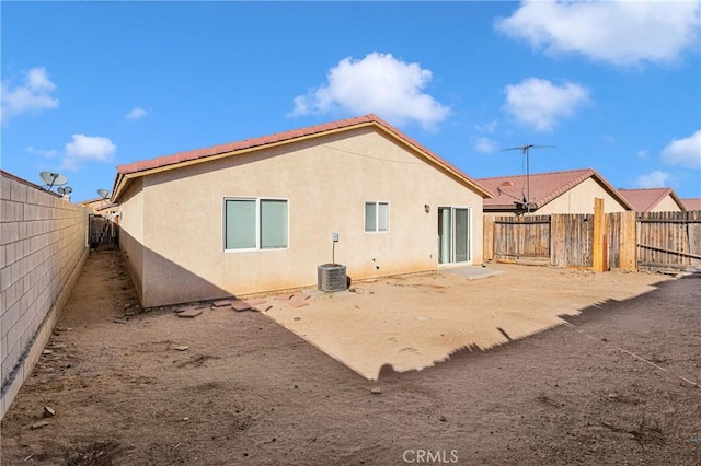 rear view of property with central AC unit