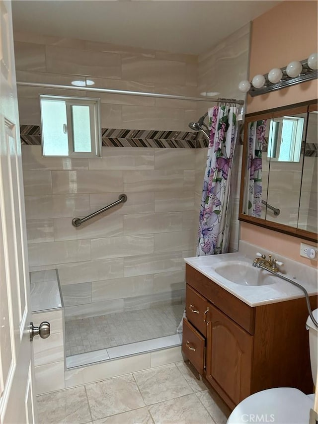 bathroom with tile patterned floors, vanity, curtained shower, and toilet