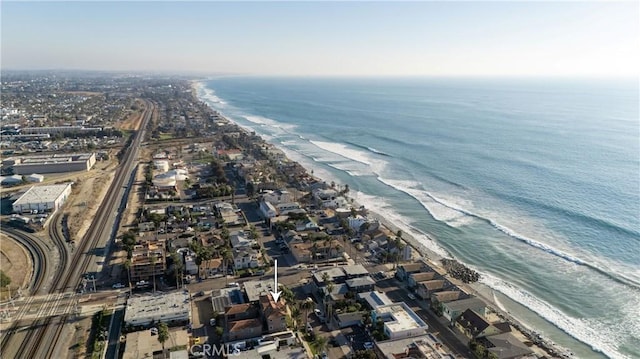 drone / aerial view with a water view and a view of the beach