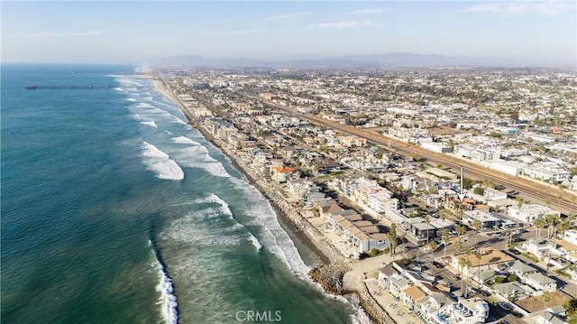 birds eye view of property with a beach view and a water view