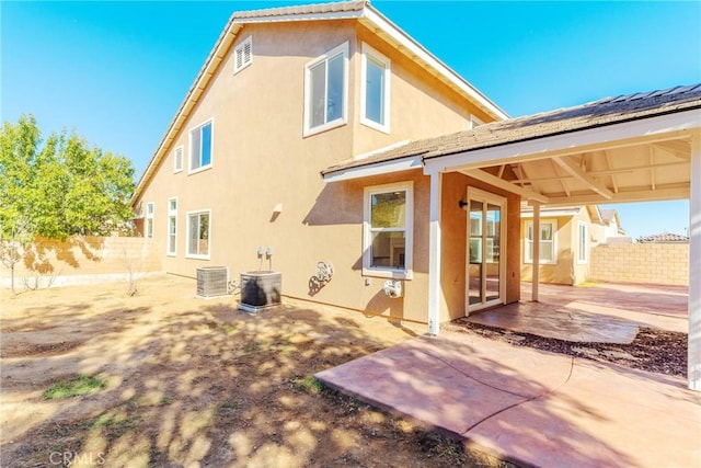 back of house featuring central AC unit and a patio