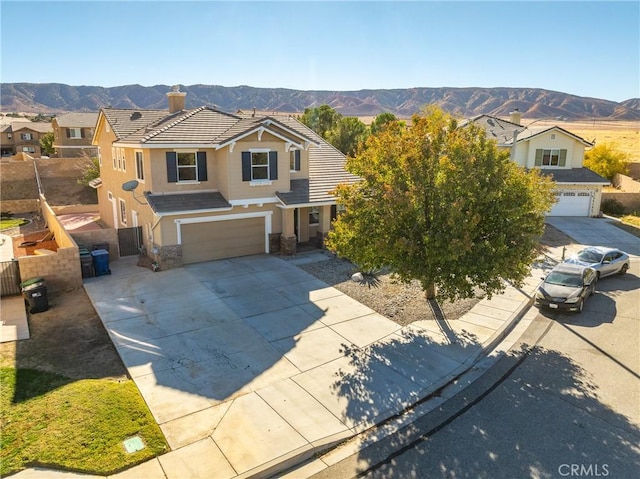 view of front of home featuring a mountain view and a garage