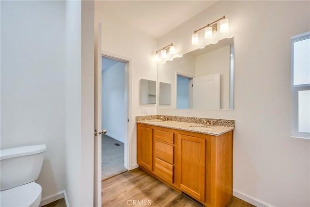 bathroom featuring hardwood / wood-style flooring, vanity, and toilet