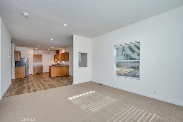 unfurnished living room featuring light hardwood / wood-style flooring