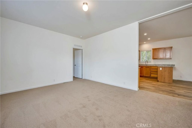 carpeted empty room with sink