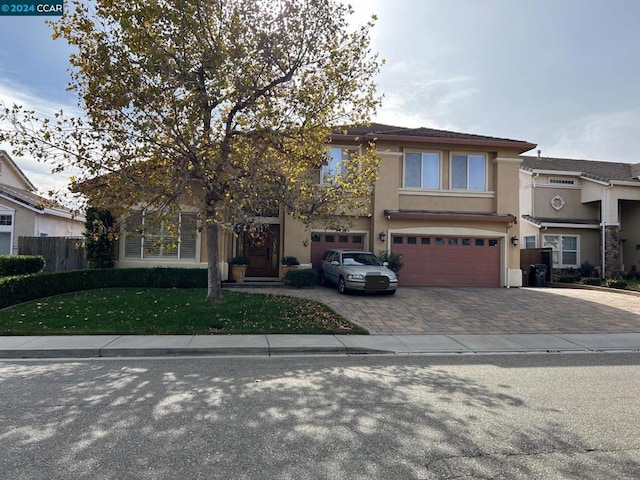 view of front of property featuring a front yard and a garage