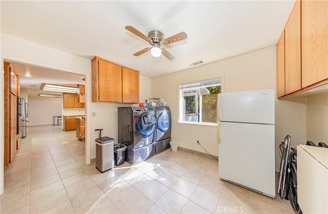 kitchen with ceiling fan, light tile patterned floors, white refrigerator, washing machine and clothes dryer, and stainless steel refrigerator