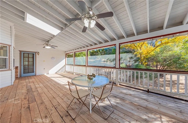 unfurnished sunroom featuring lofted ceiling with beams and ceiling fan