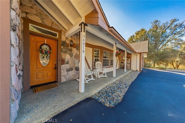 view of exterior entry featuring a porch