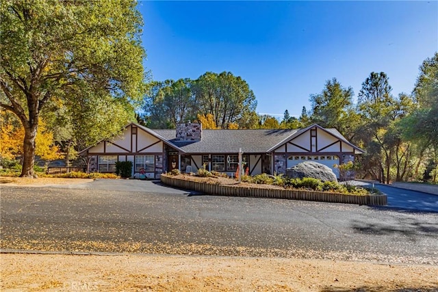 tudor-style house featuring a garage