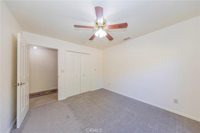 unfurnished bedroom with ceiling fan, light carpet, and a closet