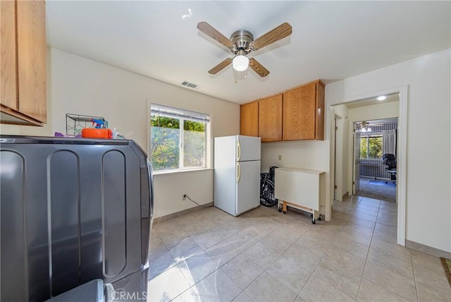 kitchen with ceiling fan, white refrigerator, light tile patterned flooring, and washer / clothes dryer