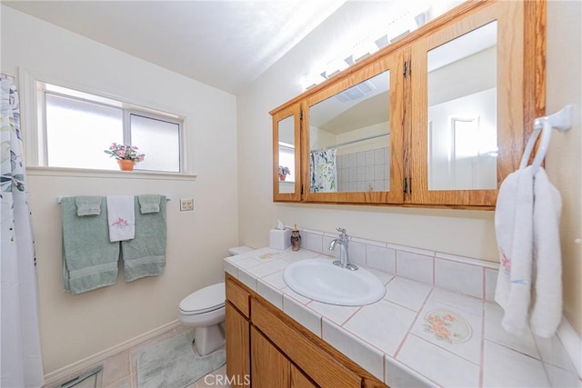 bathroom featuring tile patterned floors, vanity, and toilet