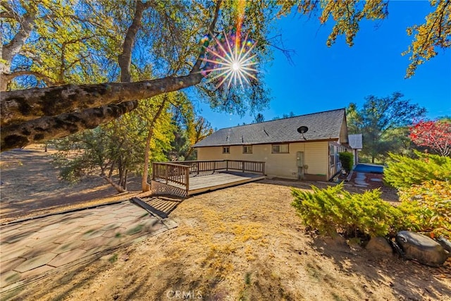 back of property featuring a deck