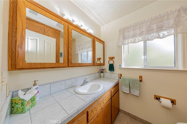 bathroom featuring tile patterned flooring and vanity