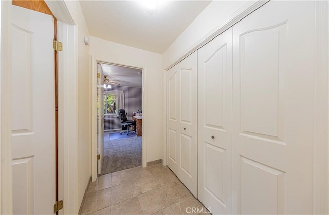 hall featuring light tile patterned floors