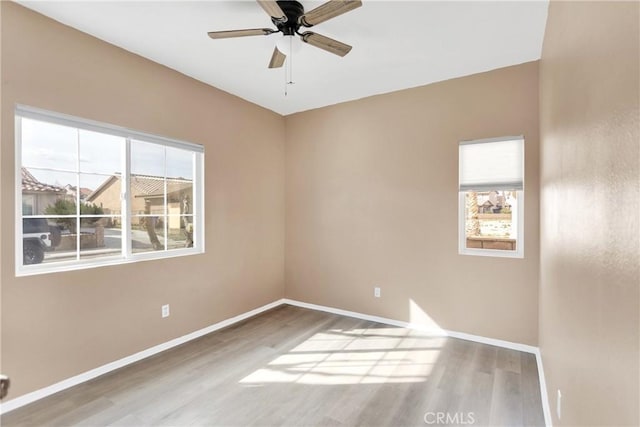 spare room featuring wood-type flooring and ceiling fan