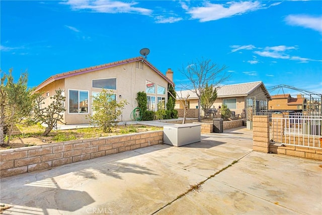 view of side of home with a patio