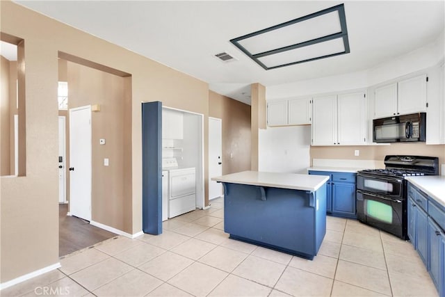 kitchen with blue cabinetry, washing machine and clothes dryer, white cabinetry, a center island, and black appliances