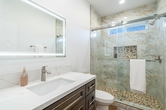 bathroom featuring vanity, toilet, and walk in shower