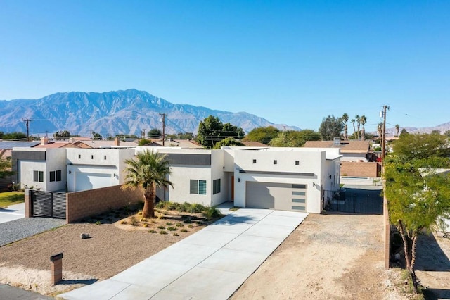 pueblo-style home with a mountain view and a garage