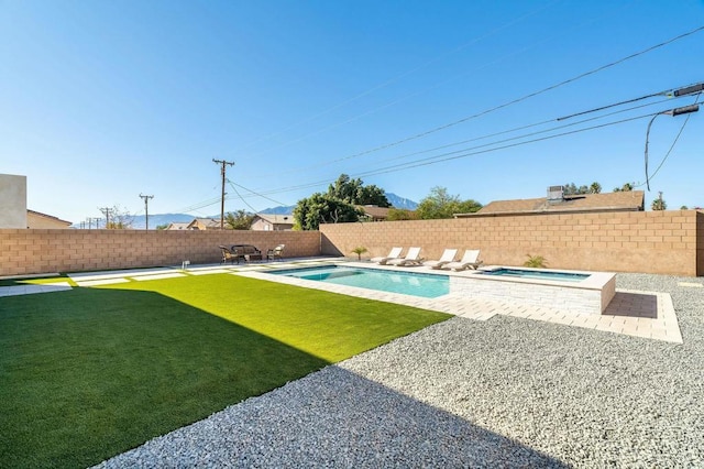 view of swimming pool featuring an in ground hot tub and a yard