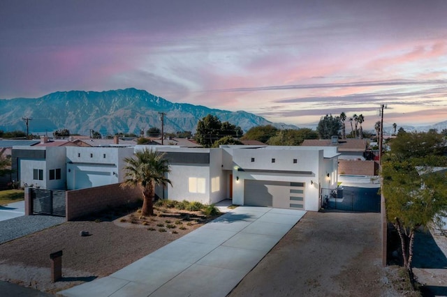 view of front of property featuring a mountain view and a garage