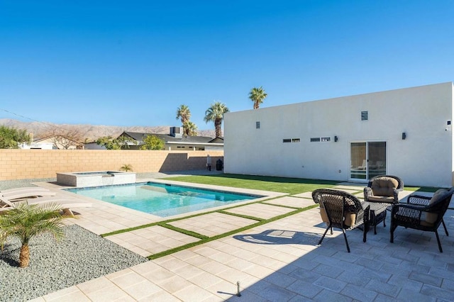 view of pool featuring a patio area and an in ground hot tub