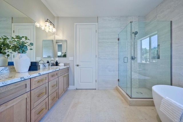 bathroom featuring separate shower and tub, tile patterned floors, and vanity