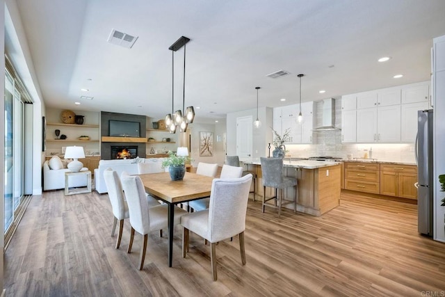 dining room featuring a wealth of natural light and light hardwood / wood-style floors