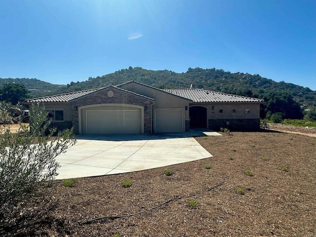 view of property exterior with a mountain view and a garage