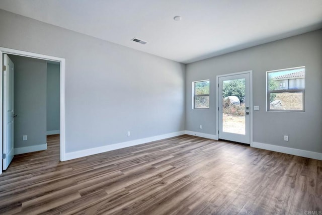 spare room featuring wood-type flooring