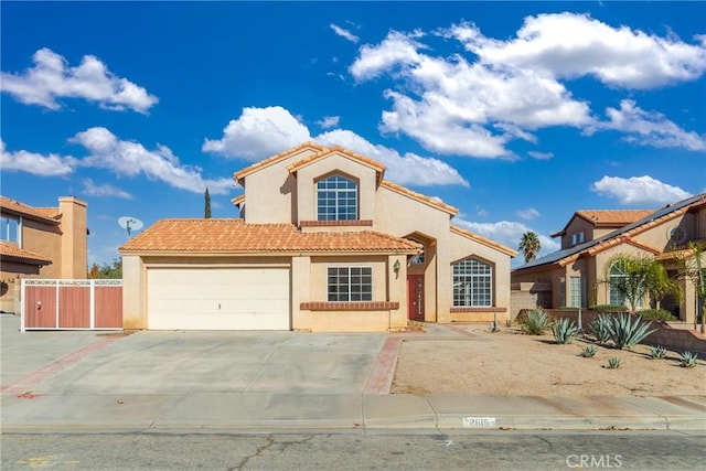 mediterranean / spanish home featuring a garage