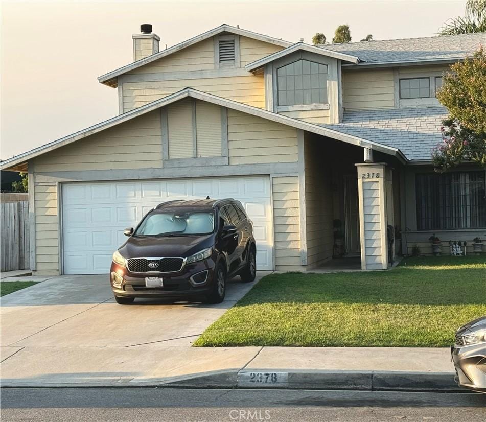 view of front of property with a garage and a front yard