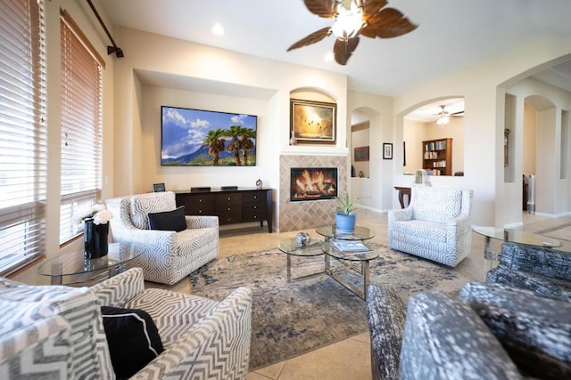 tiled living room with built in shelves and a tile fireplace