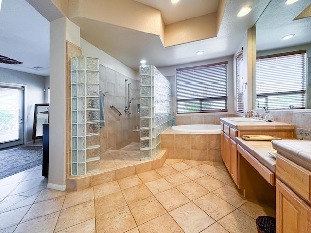 bathroom with vanity, tile patterned flooring, plenty of natural light, and plus walk in shower