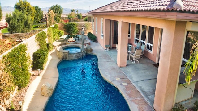 view of swimming pool with a mountain view, an in ground hot tub, and a patio