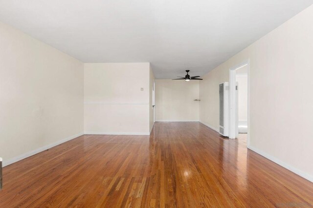 empty room featuring hardwood / wood-style flooring and ceiling fan