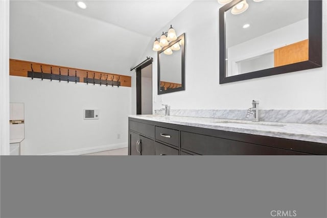 bathroom with vanity, tile patterned floors, and vaulted ceiling