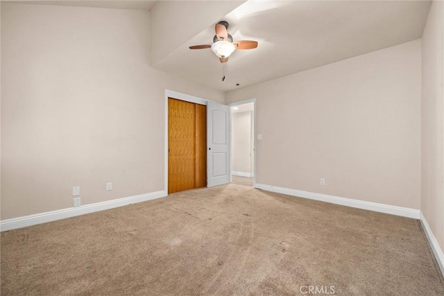 unfurnished bedroom featuring carpet flooring, ceiling fan, and a closet