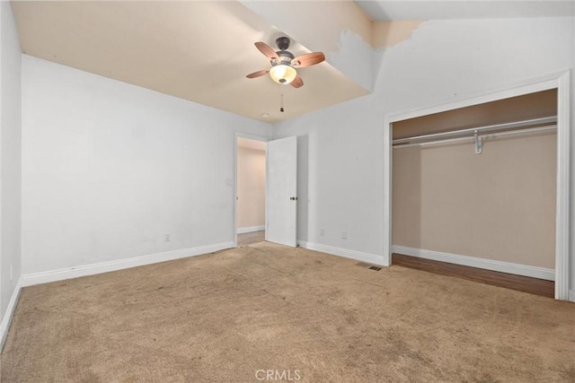 unfurnished bedroom featuring carpet floors, a closet, and ceiling fan