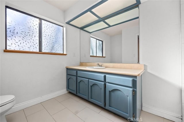 bathroom with tile patterned flooring, vanity, and toilet