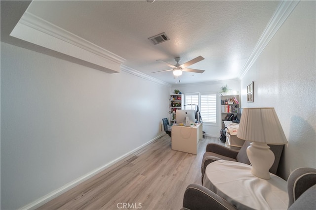 living area with ceiling fan, crown molding, a textured ceiling, and light hardwood / wood-style flooring