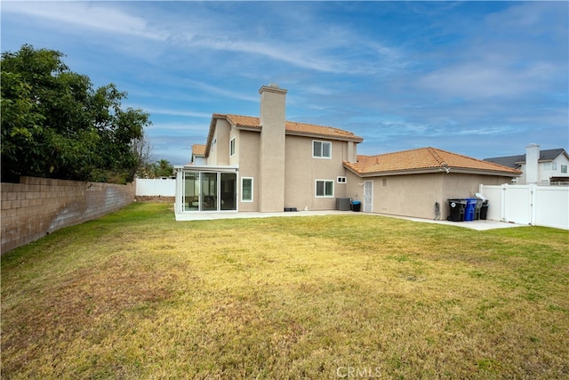 rear view of house featuring a patio area, a lawn, and central air condition unit