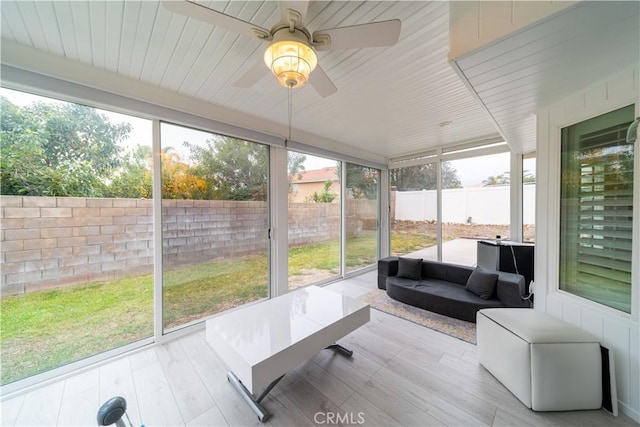 sunroom / solarium with ceiling fan and a wealth of natural light