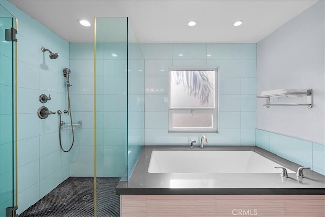 bathroom featuring separate shower and tub