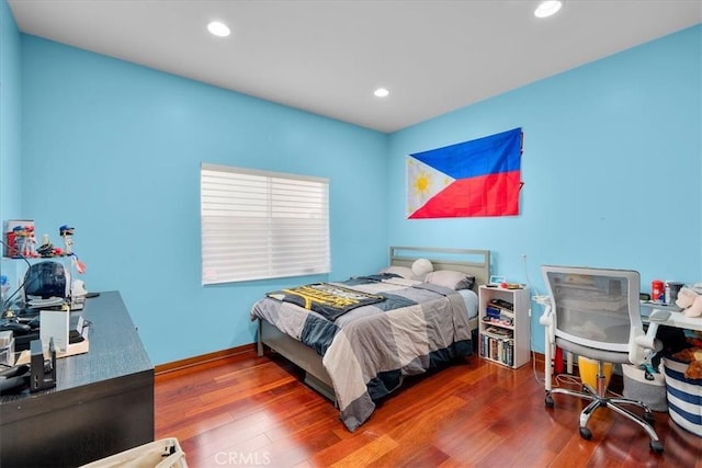 bedroom with hardwood / wood-style flooring